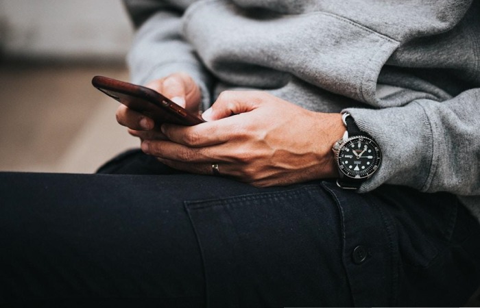 Nonprofit manager testing out mass texting software for nonprofits while sitting down